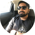 a person in sunglasses sitting in the back seat of a car