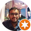 a person sitting at a table with an orange star on it